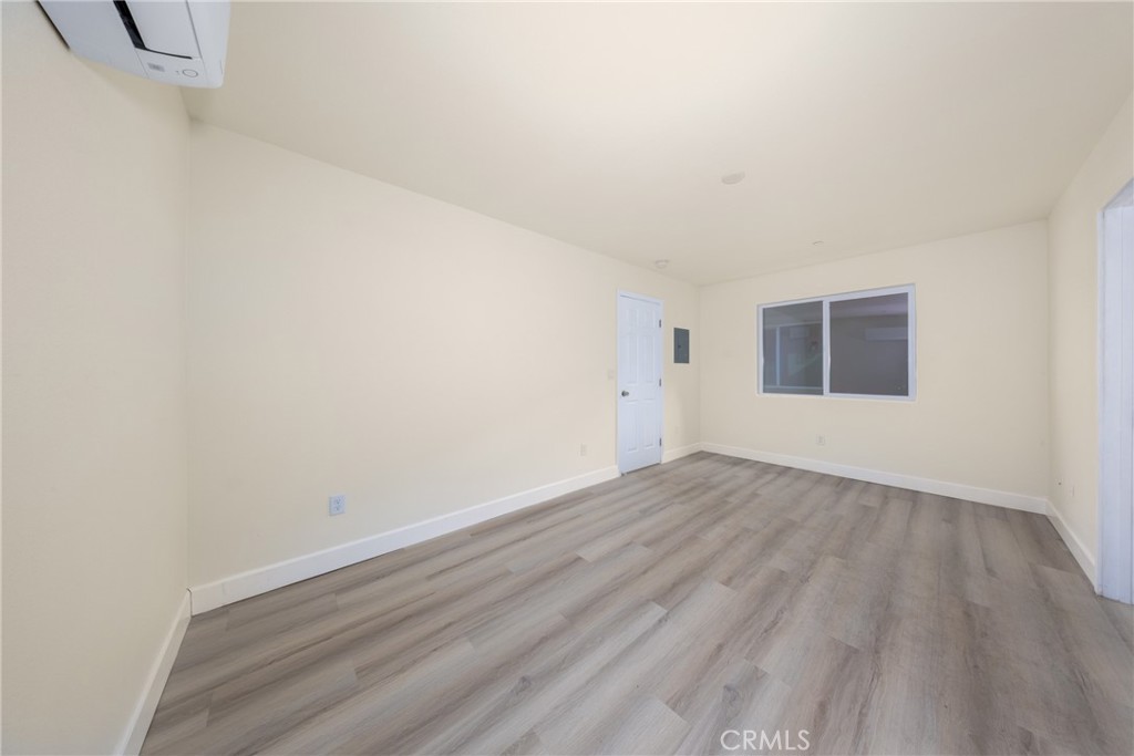 16241 Chestnut Street Hesperia, CA 92345 - Photo 47 of 60 a view of an empty room with wooden floor and a window