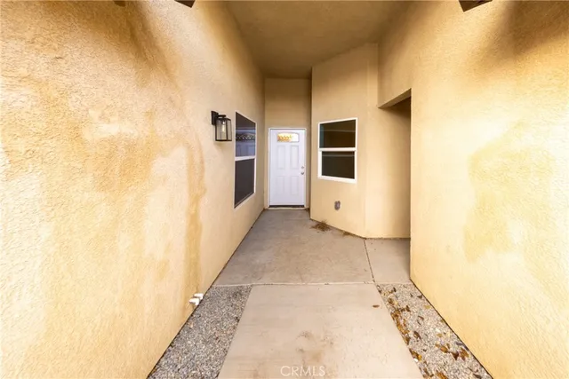 a view of a kitchen with wooden floor and window