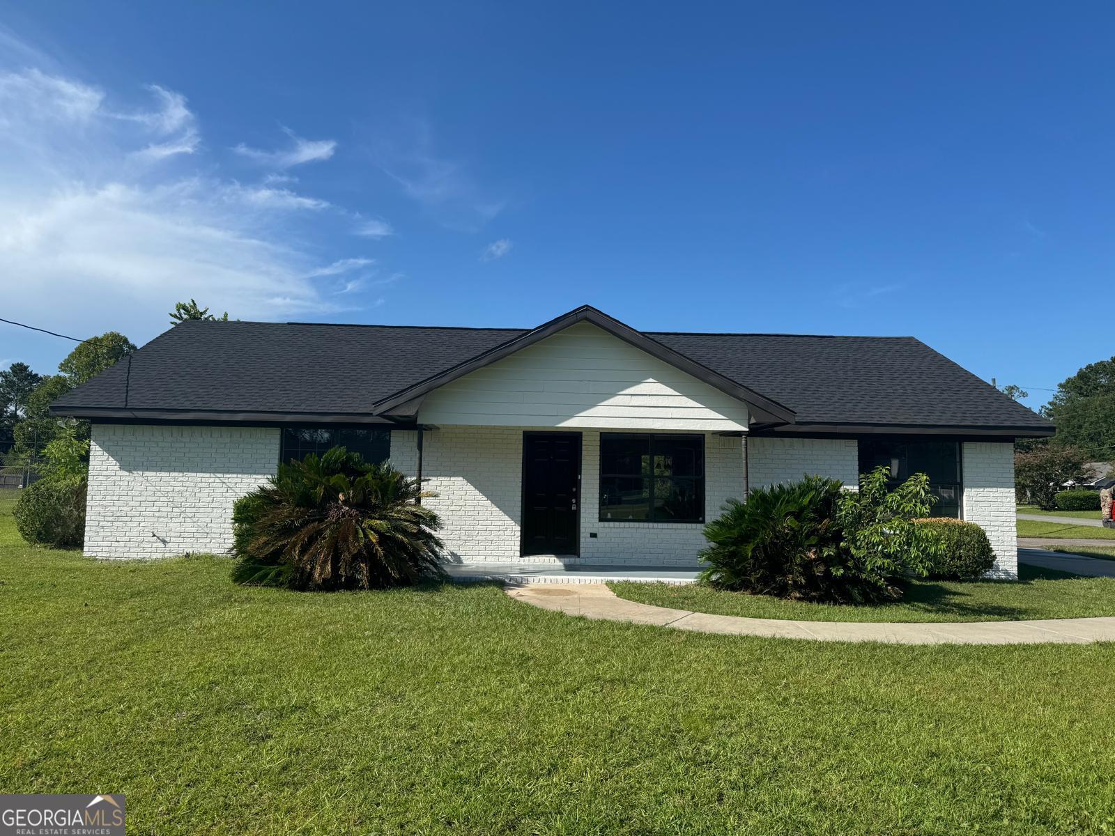 9 Ashlynn Lane Midway, GA 31320 - Photo 1 of 1 a front view of a house with a garden