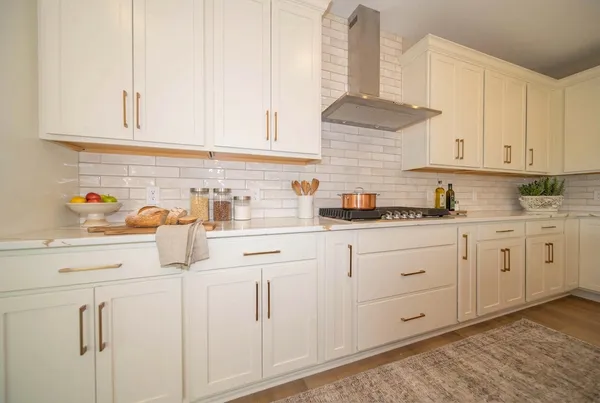 a kitchen with stainless steel appliances white cabinets and a sink