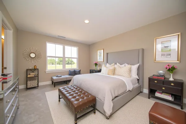 a spacious bedroom with a bed and a couch