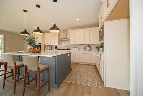 a kitchen with stainless steel appliances kitchen island granite countertop a sink a counter space and cabinets