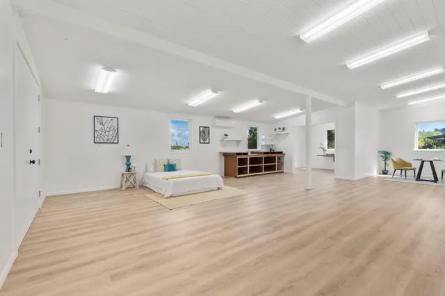 a view of a livingroom with kitchen and furniture