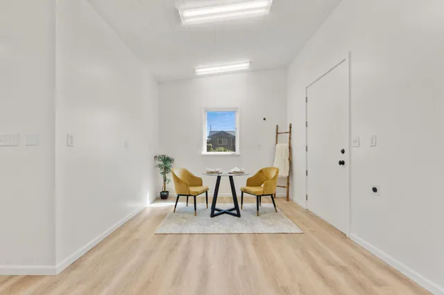 a view of dining room with furniture and wooden floor