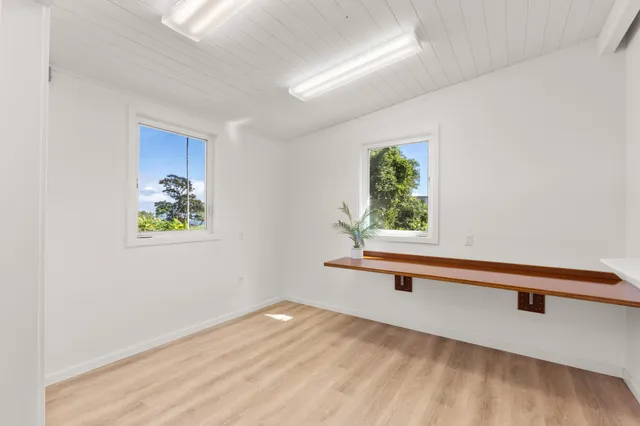 a view of room with window and wooden floor