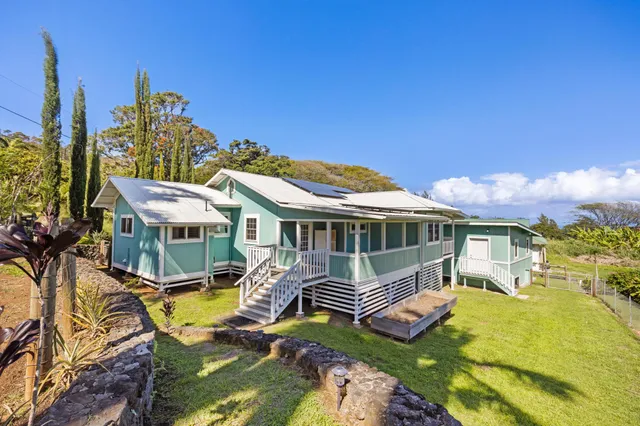a view of a house with pool and chairs