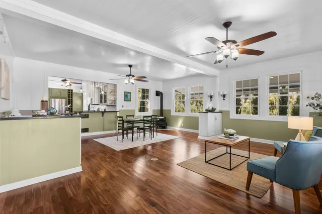 a living room with furniture and kitchen view