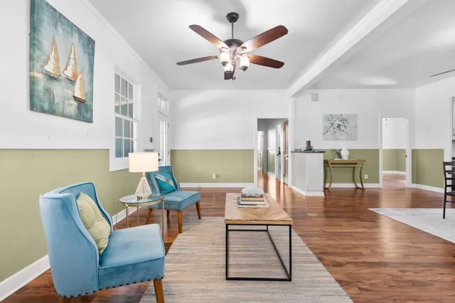 a living room with furniture and wooden floor