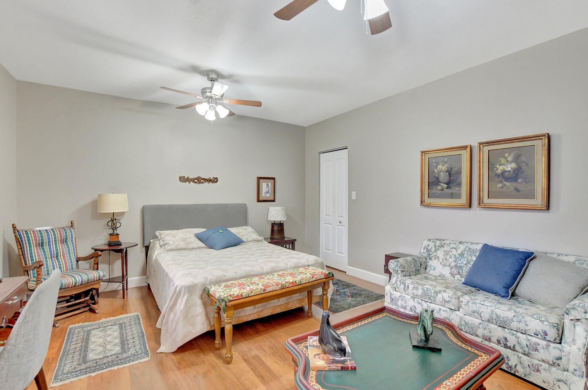 9717 Erica Court Boca Raton, FL 33496 - Photo 12 of 49 a bedroom with a bed and a chandelier