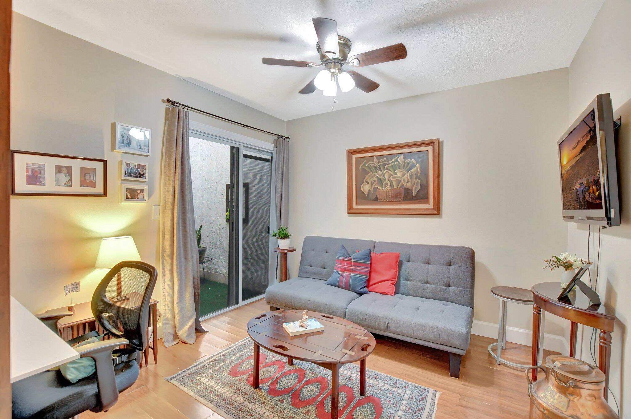 9717 Erica Court Boca Raton, FL 33496 - Photo 13 of 49 a living room with furniture a flat screen tv and a window