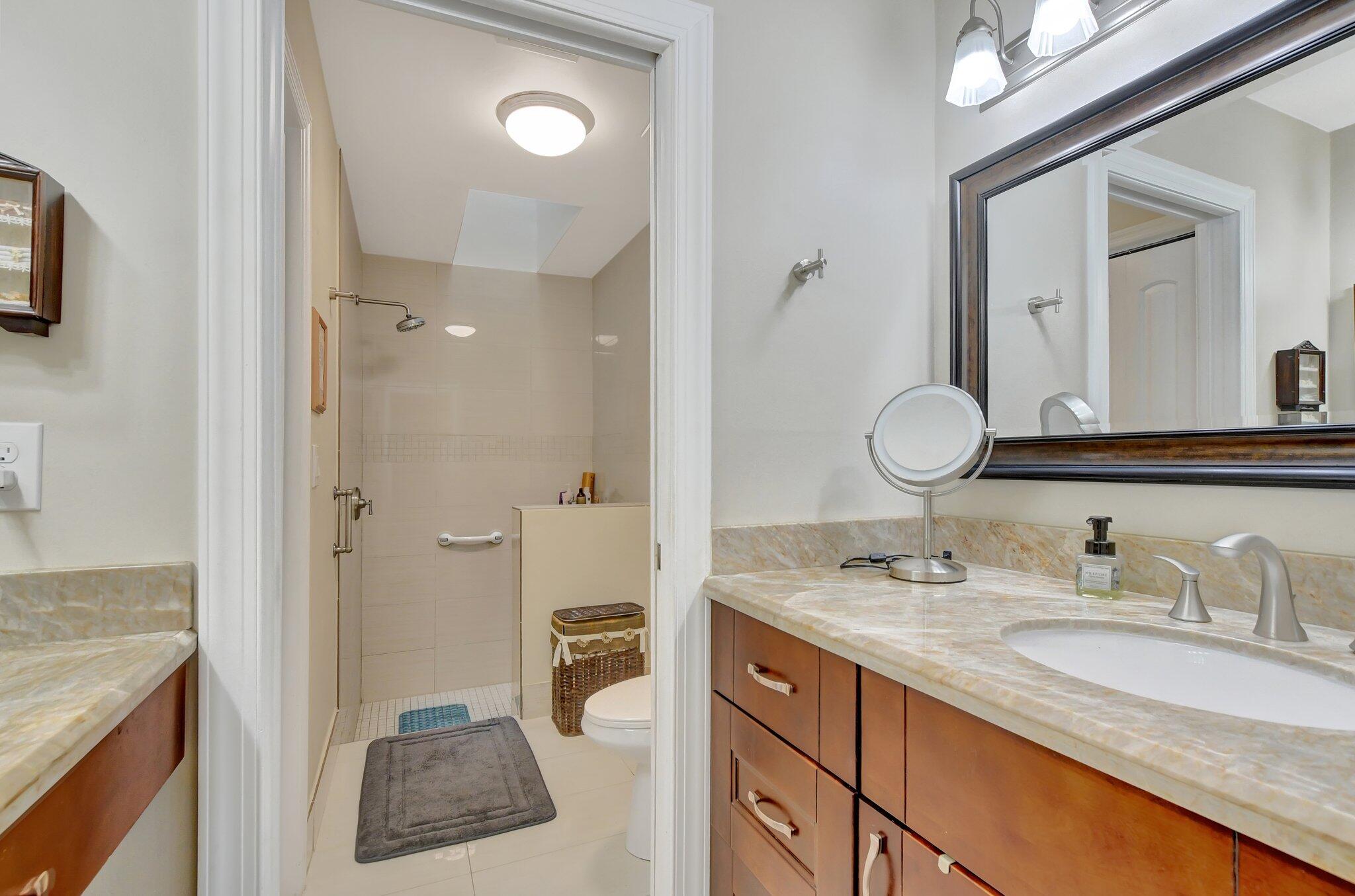 9717 Erica Court Boca Raton, FL 33496 - Photo 17 of 49 a bathroom with a granite countertop sink mirror and double