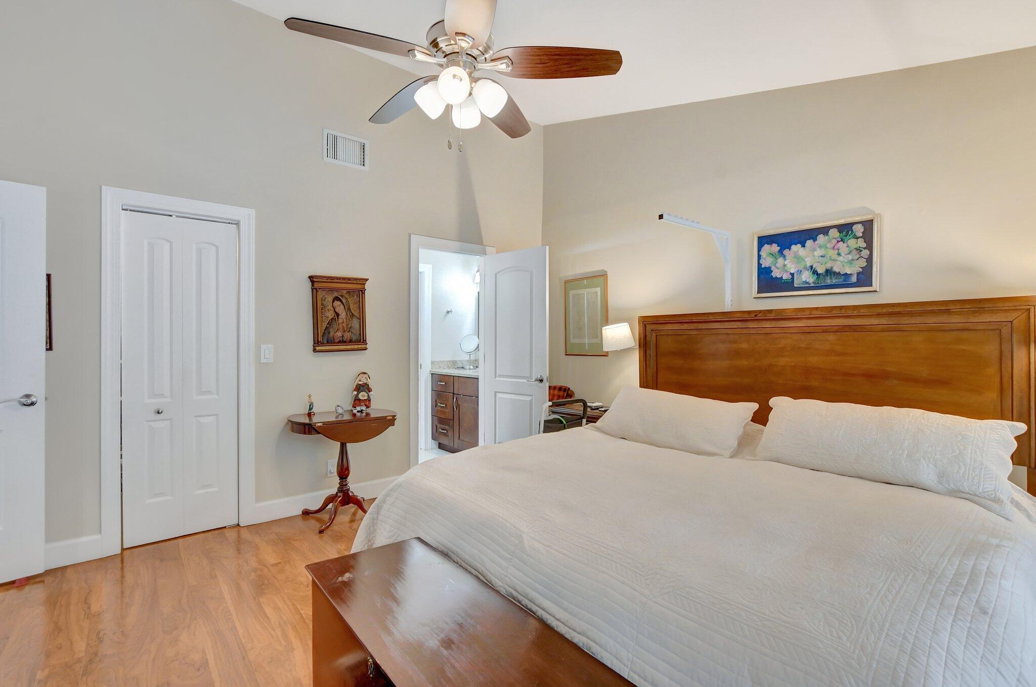 9717 Erica Court Boca Raton, FL 33496 - Photo 18 of 49 a bedroom with a bed and a chandelier