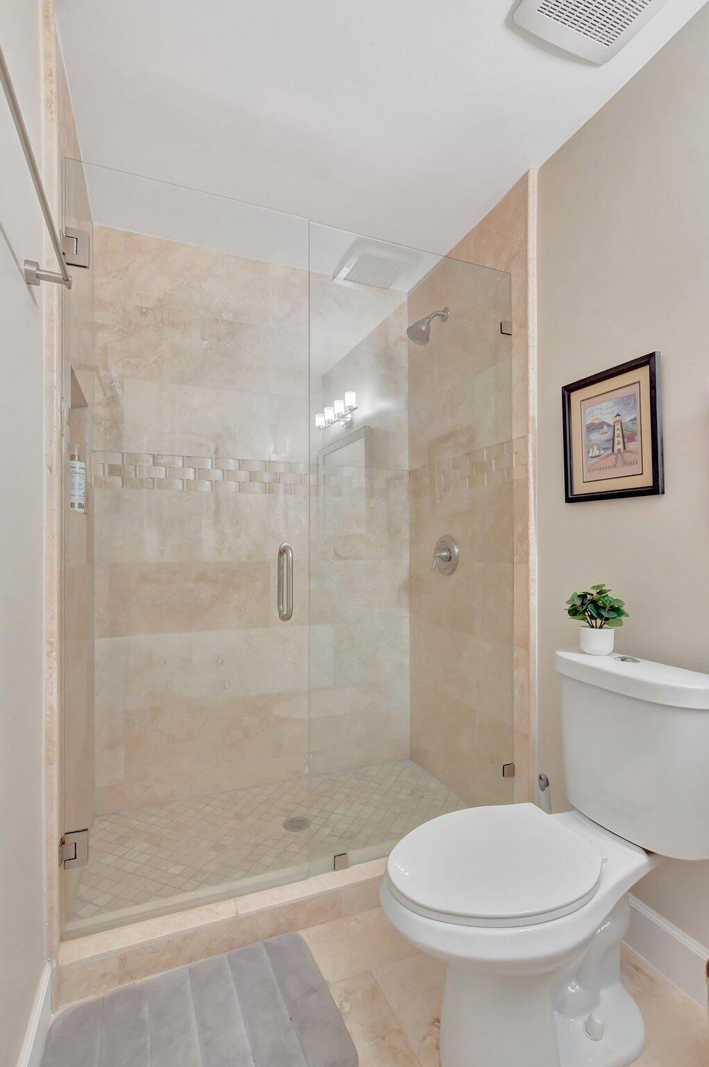 9717 Erica Court Boca Raton, FL 33496 - Photo 21 of 49 a bathroom with a toilet and a shower