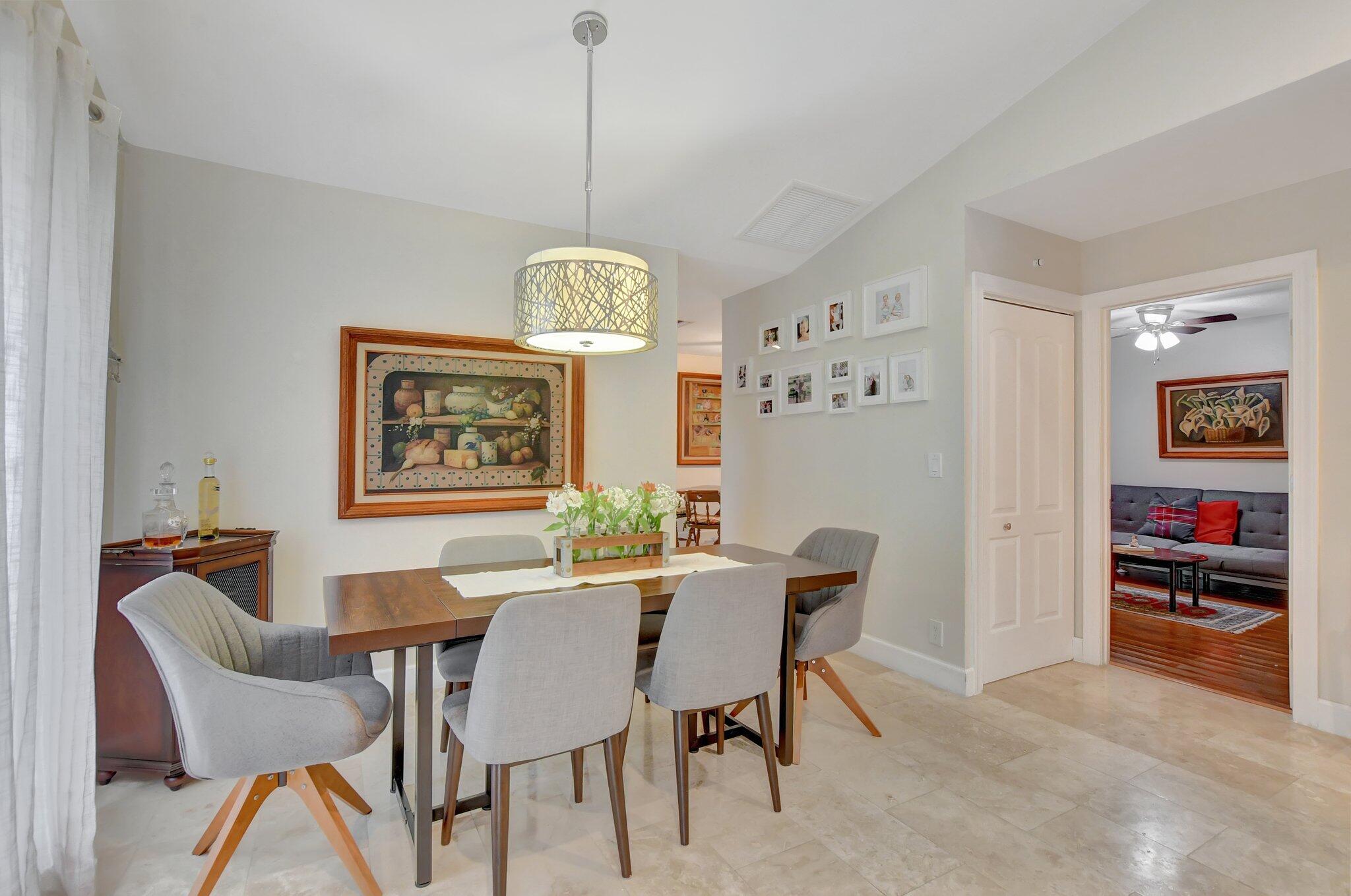 9717 Erica Court Boca Raton, FL 33496 - Photo 23 of 49 a view of a dining room with furniture window and wooden floor