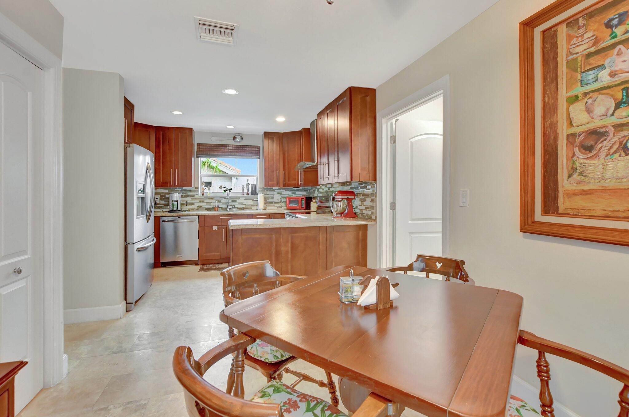 9717 Erica Court Boca Raton, FL 33496 - Photo 24 of 49 a living room with stainless steel appliances furniture a rug and a kitchen view