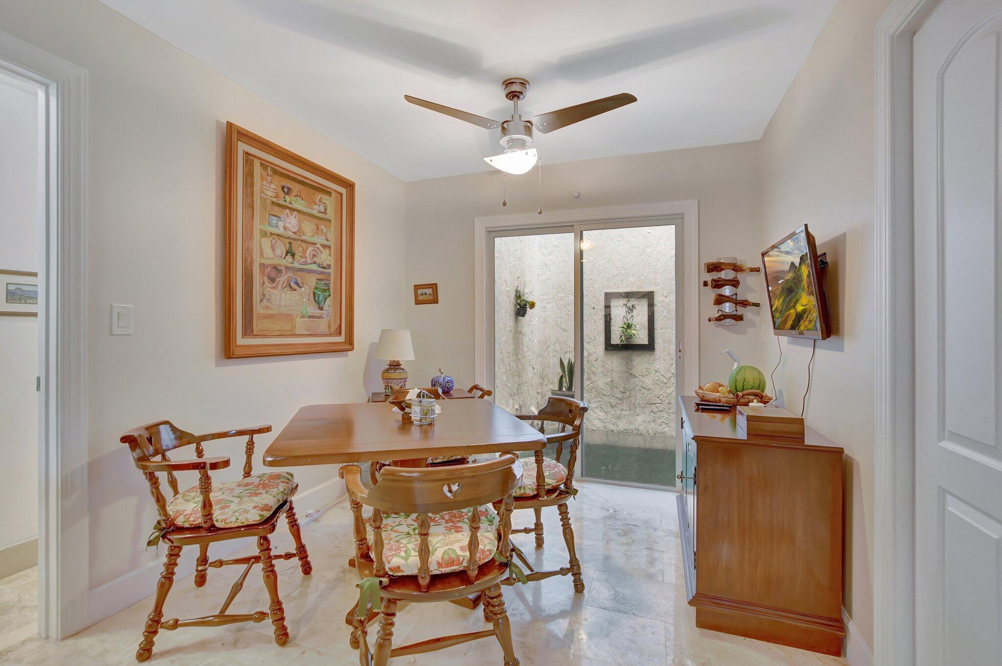 9717 Erica Court Boca Raton, FL 33496 - Photo 25 of 49 a dining room with furniture and window