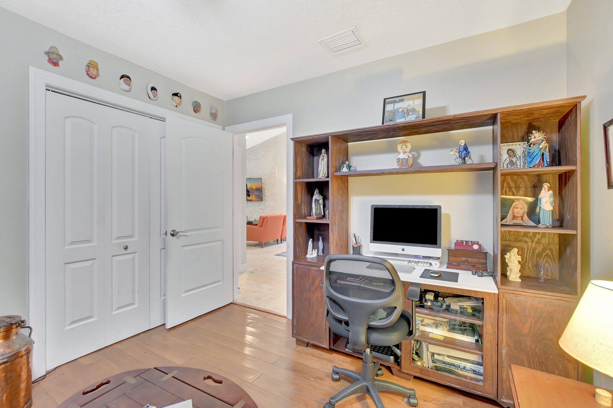 9717 Erica Court Boca Raton, FL 33496 - Photo 28 of 49 a workspace with furniture and wooden floor