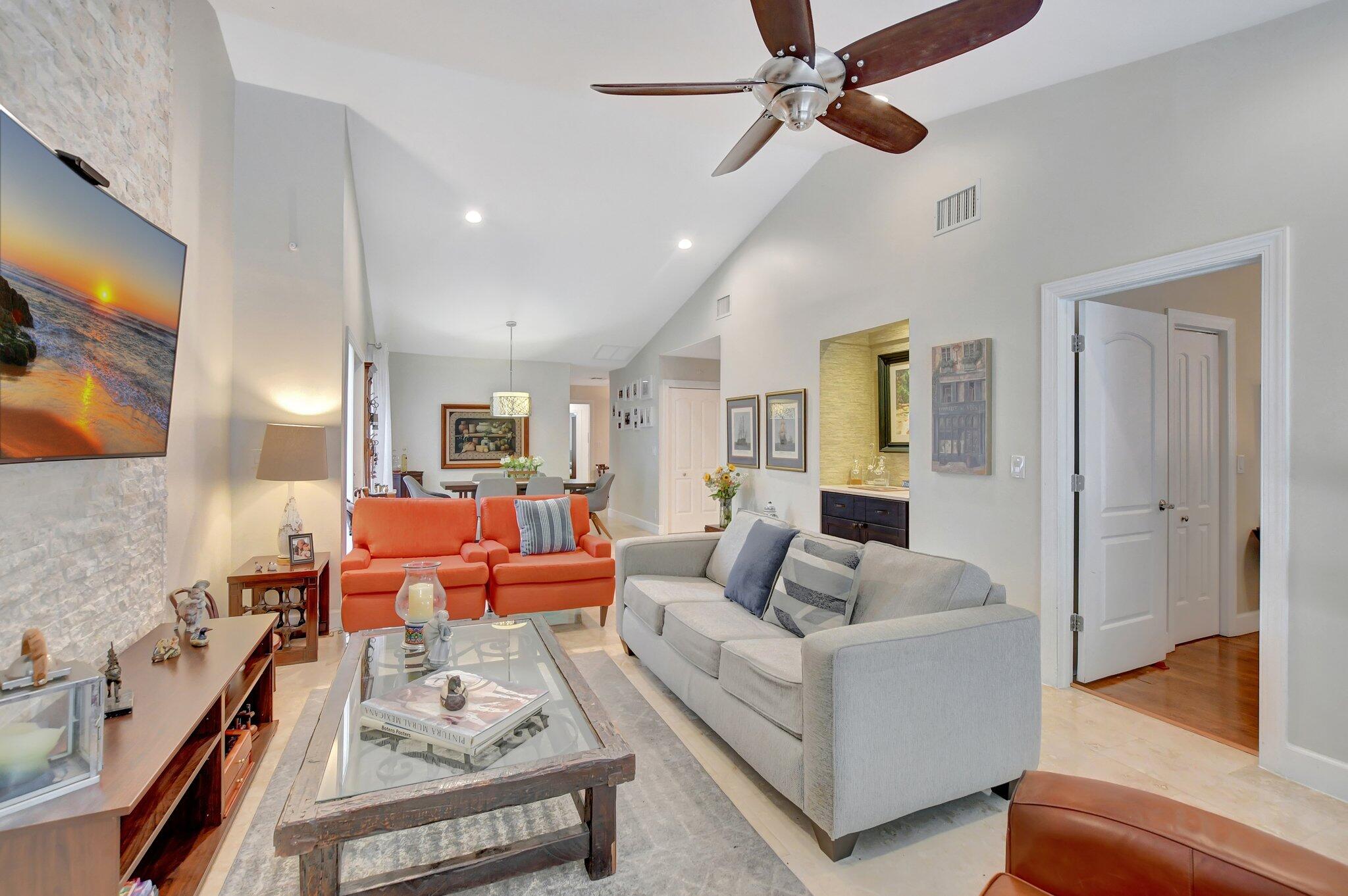 9717 Erica Court Boca Raton, FL 33496 - Photo 32 of 49 a living room with furniture and a flat screen tv