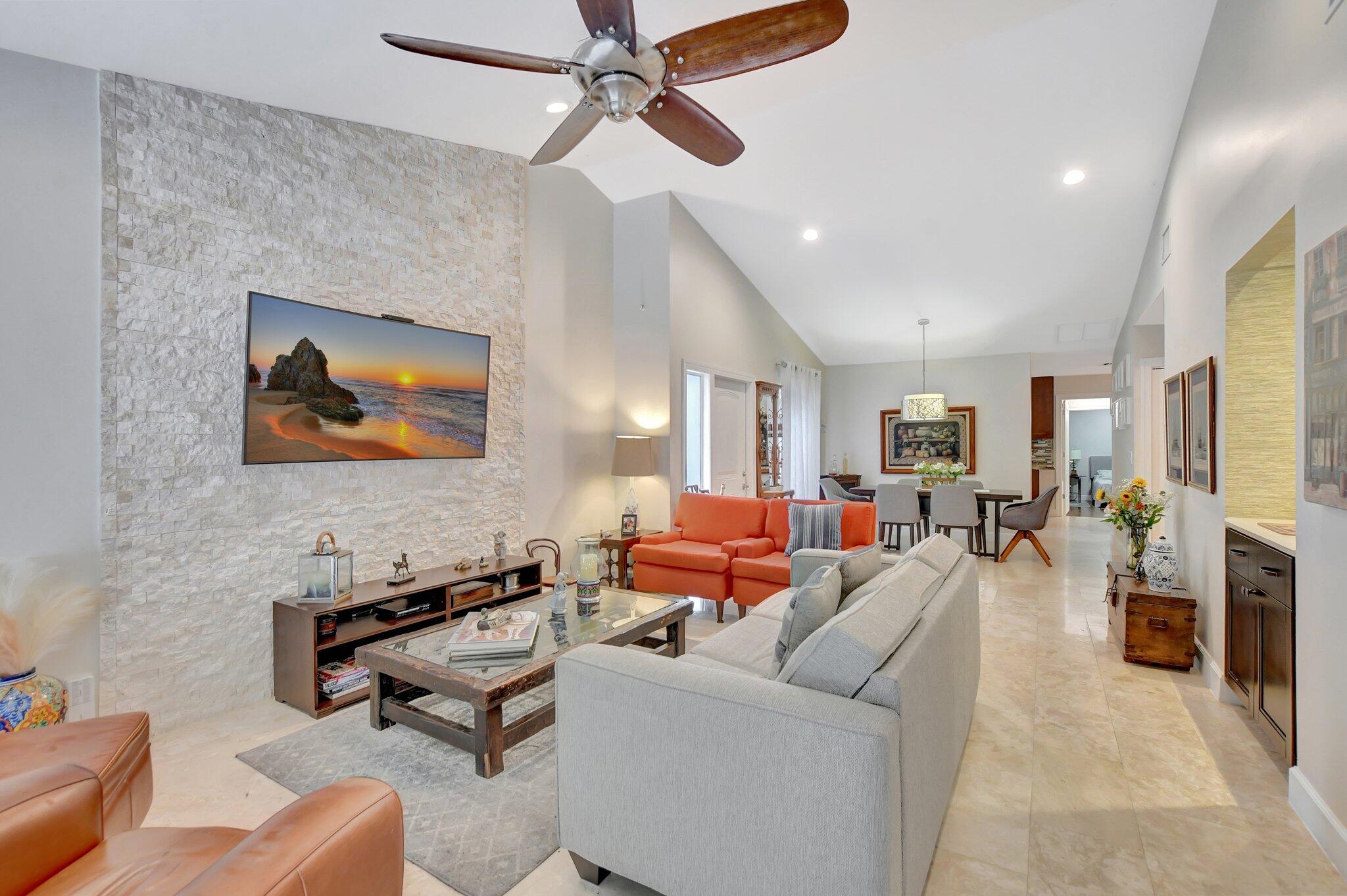 9717 Erica Court Boca Raton, FL 33496 - Photo 33 of 49 a living room with furniture a fireplace and a flat screen tv