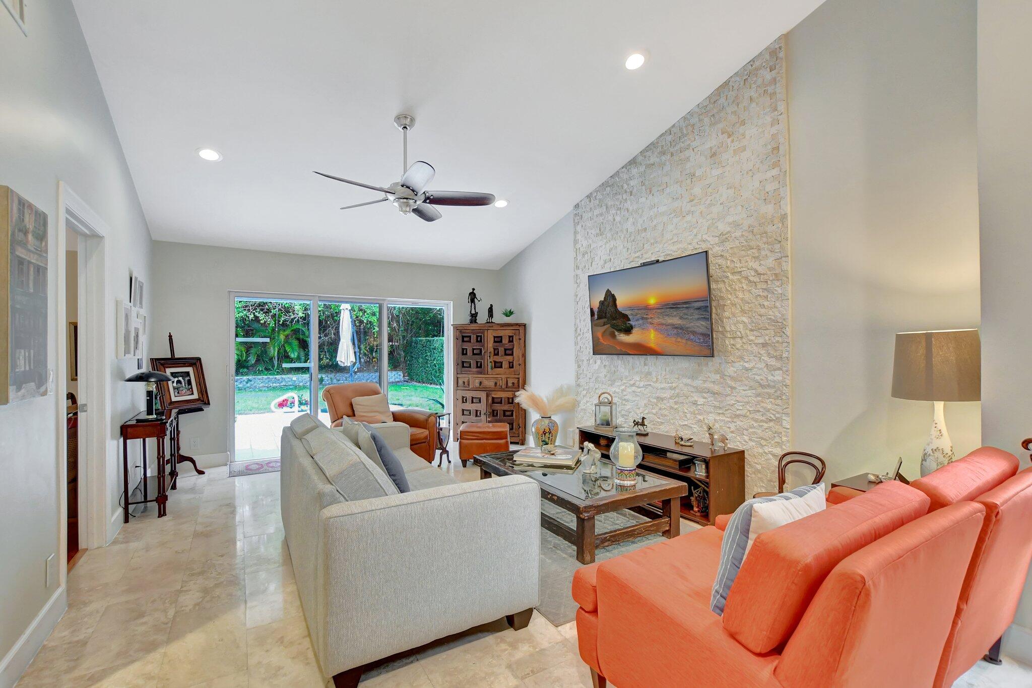 9717 Erica Court Boca Raton, FL 33496 - Photo 35 of 49 a living room with furniture a fireplace and a large window