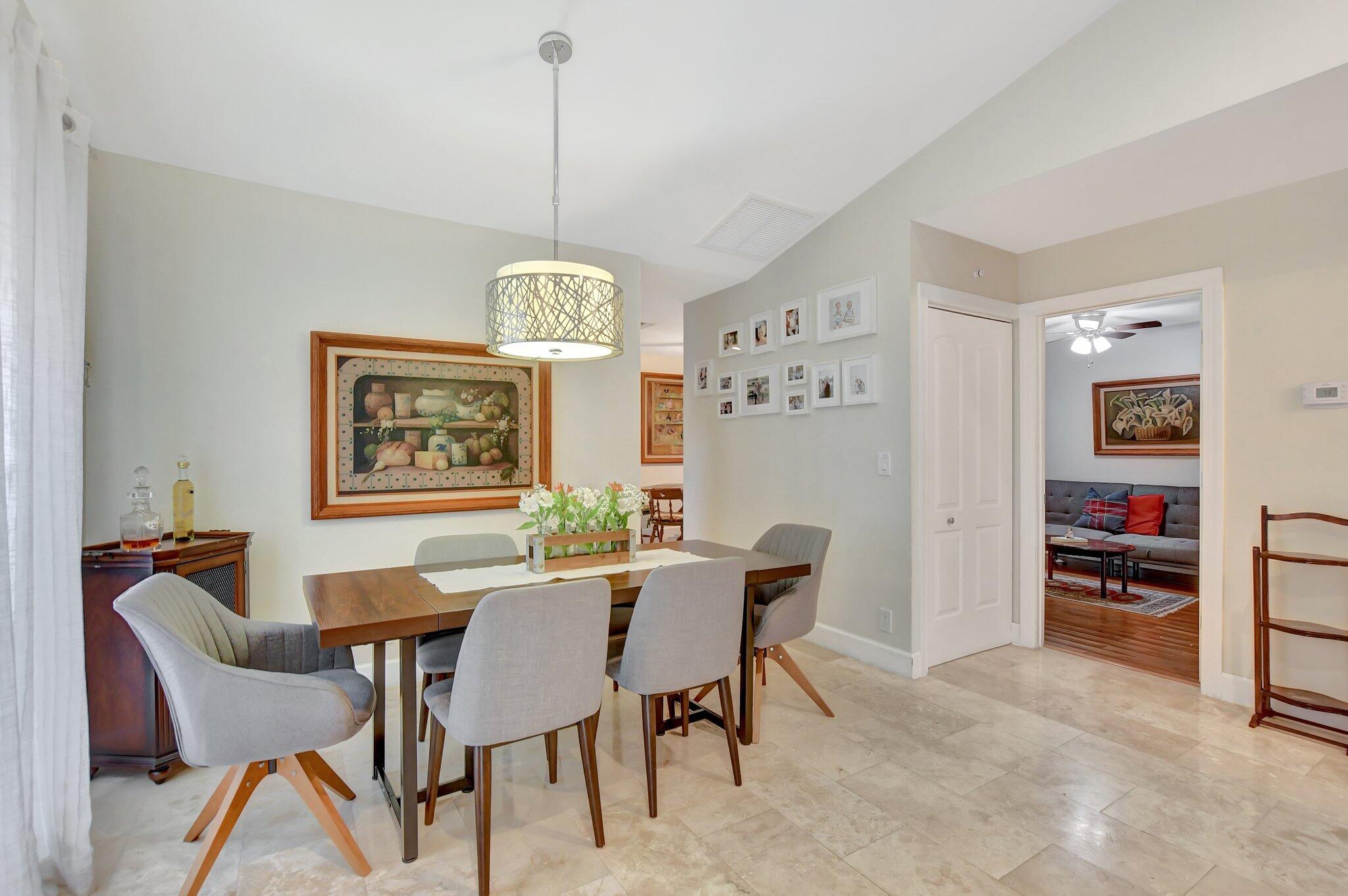 9717 Erica Court Boca Raton, FL 33496 - Photo 37 of 49 a view of a dining room with furniture window and wooden floor