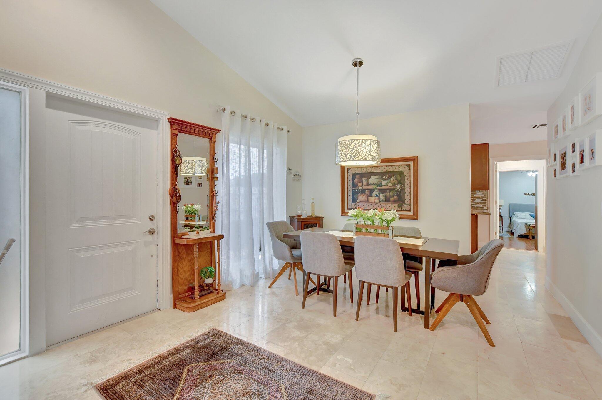 9717 Erica Court Boca Raton, FL 33496 - Photo 38 of 49 a view of a dining room with furniture window and wooden floor