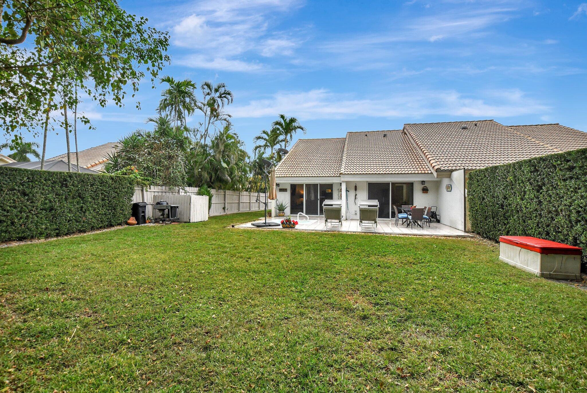 9717 Erica Court Boca Raton, FL 33496 - Photo 6 of 49 a front view of house with yard and outdoor seating