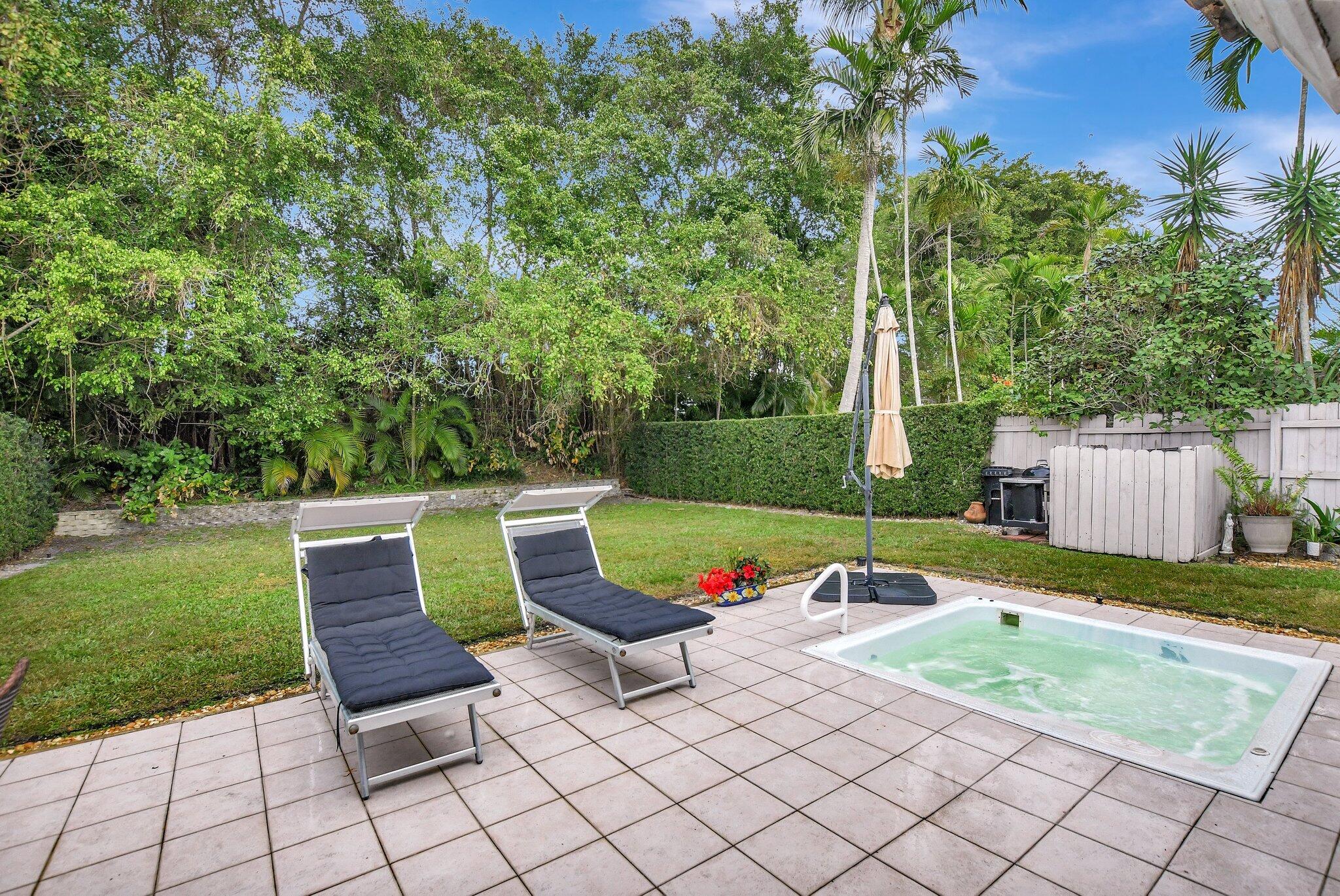 9717 Erica Court Boca Raton, FL 33496 - Photo 7 of 49 an outdoor sitting area with chairs and a table