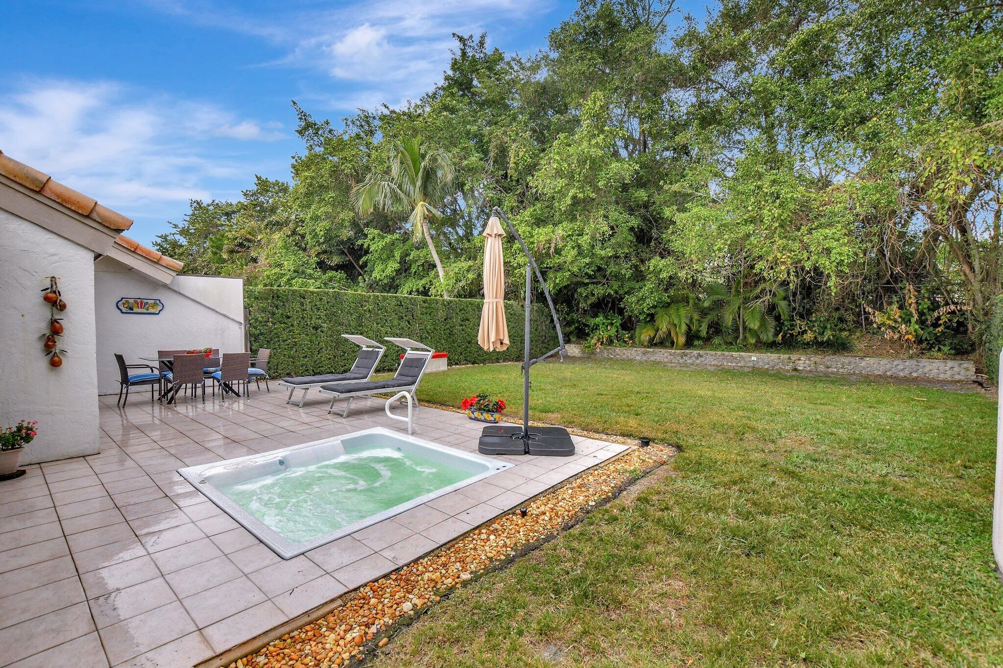 9717 Erica Court Boca Raton, FL 33496 - Photo 10 of 49 a view of a backyard with sitting area
