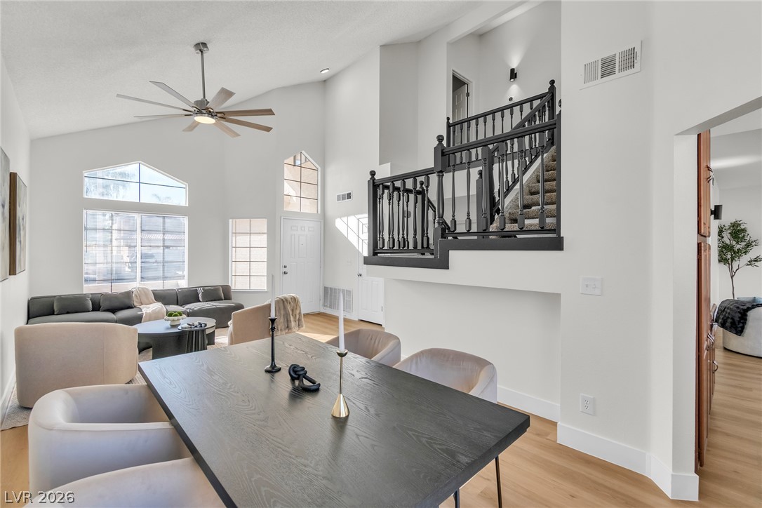 370 Rushing Creek Court Henderson, NV 89014 - Photo 7 of 32 Dramatic vaulted ceilings and a stylish staircase define this open living and dining area.