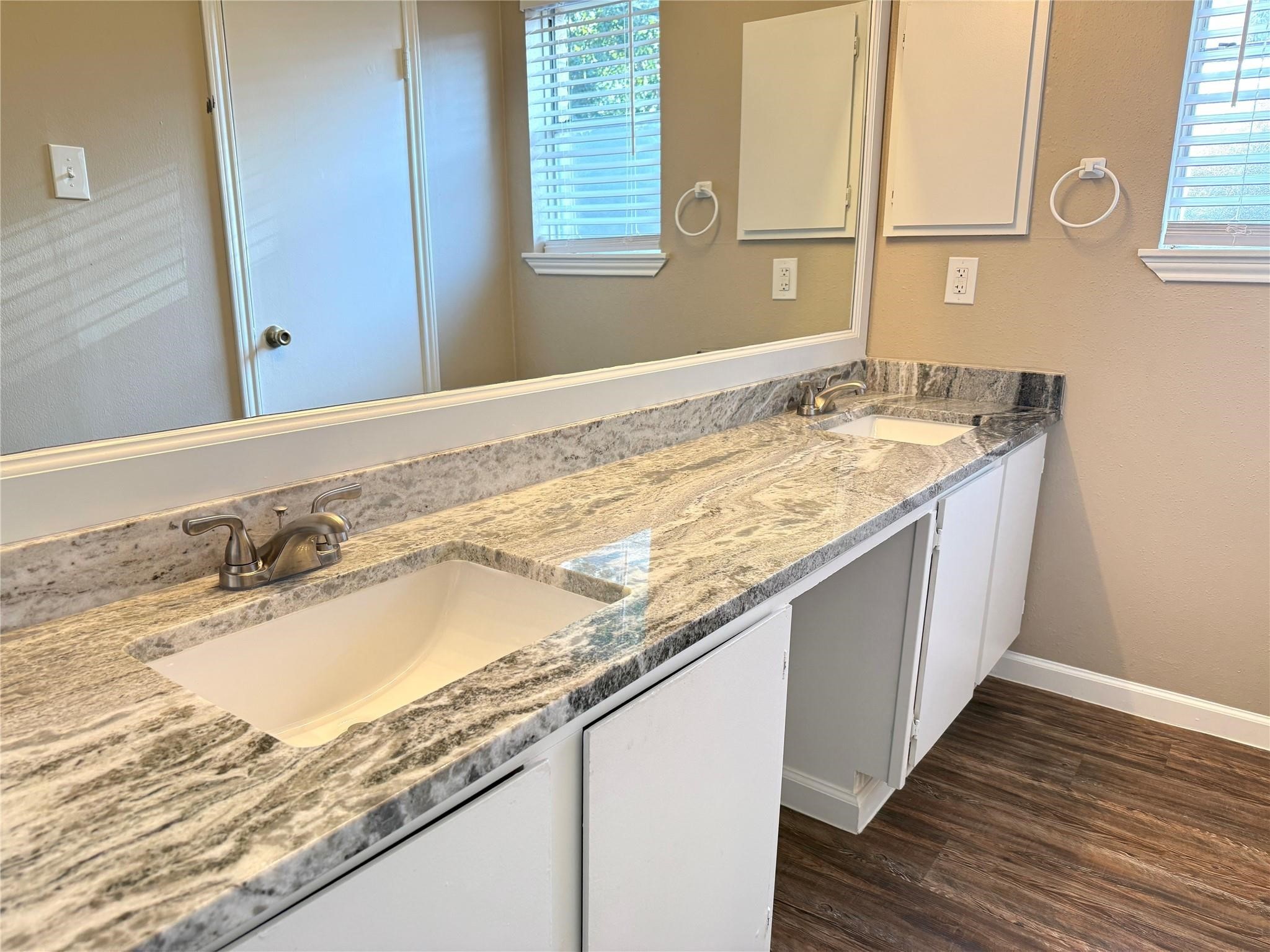 2435 Summer Spring Drive Spring, TX 77373 - Photo 11 of 16 a bathroom with a granite countertop sink and a wooden floor