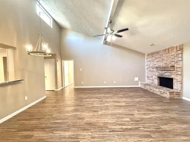 wooden floor in an empty room with a fireplace