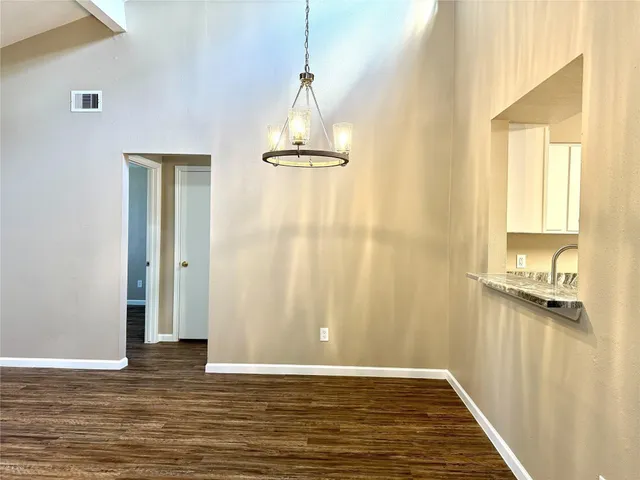 a view of a livingroom with wooden floor and a window