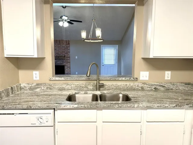 a kitchen with stainless steel appliances granite countertop a sink and a wooden cabinets