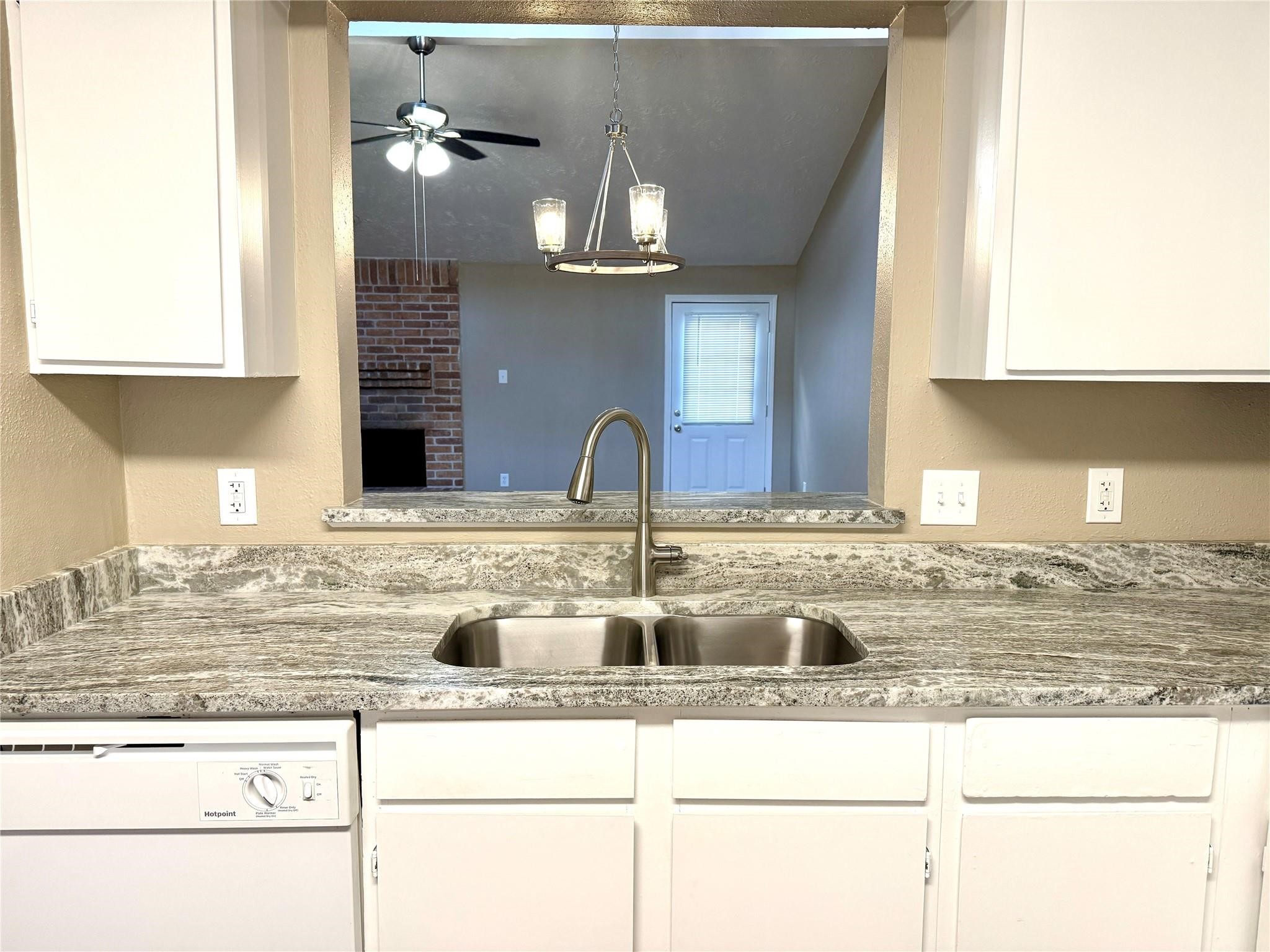 2435 Summer Spring Drive Spring, TX 77373 - Photo 9 of 16 a kitchen with stainless steel appliances granite countertop a sink and a wooden cabinets
