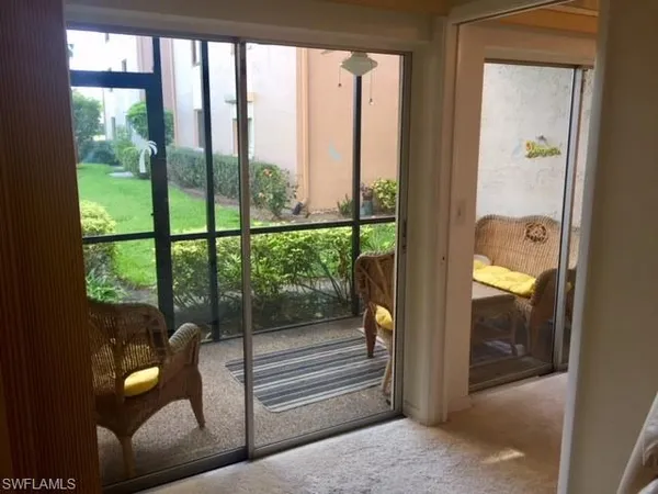 a porch with a glass door and glass door