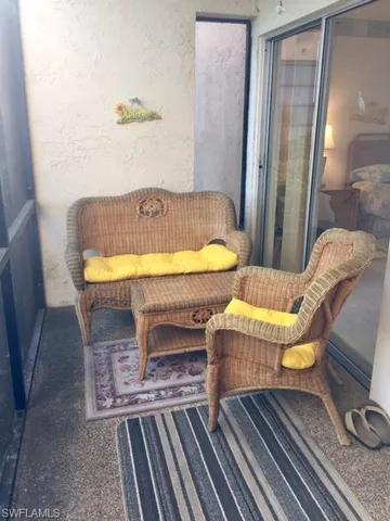 a bathroom with a tub sink and wooden floor