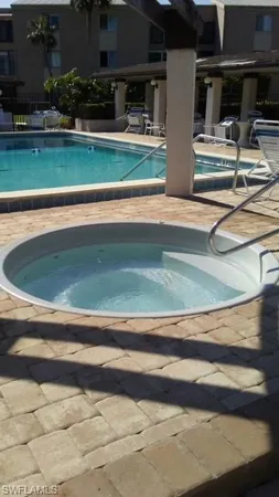 a view of backyard with swimming pool and outdoor seating