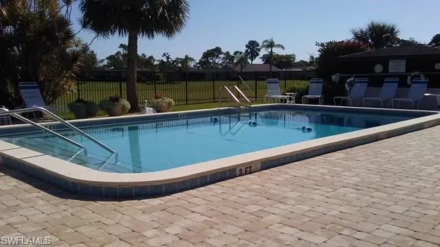 a view of a swimming pool with a chair and tables