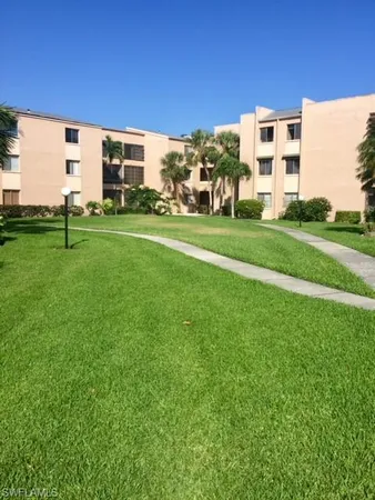a view of a building with a yard