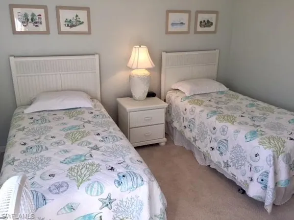 a bedroom with a bed and a lamp