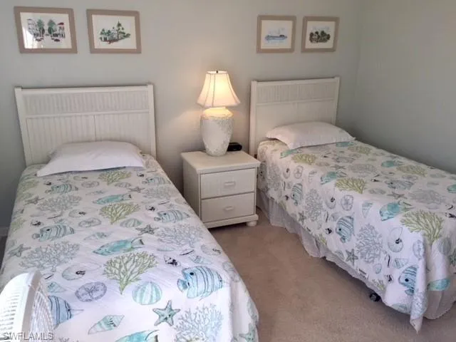 a bedroom with a bed and a lamp