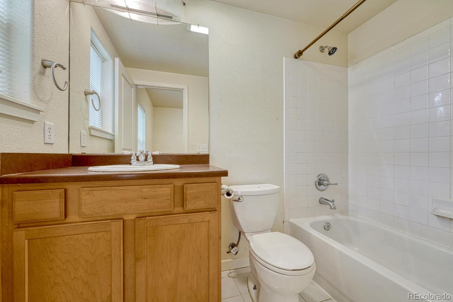 2389 South High Street, Unit 4 Denver, CO 80210 - Photo 12 of 27 a bathroom with a sink a toilet and a bathtub