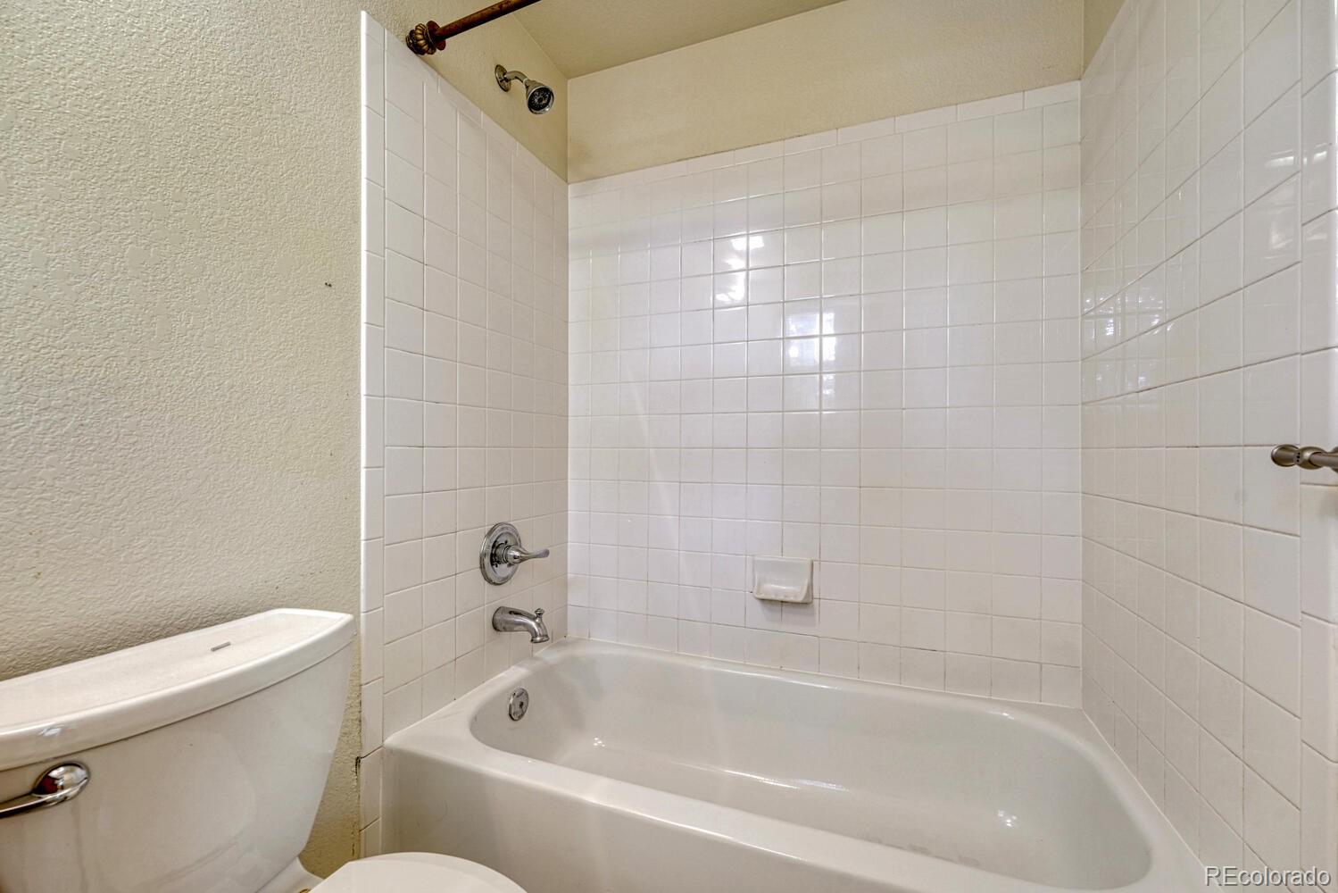 2389 South High Street, Unit 4 Denver, CO 80210 - Photo 13 of 27 a bathroom with a bathtub and a toilet