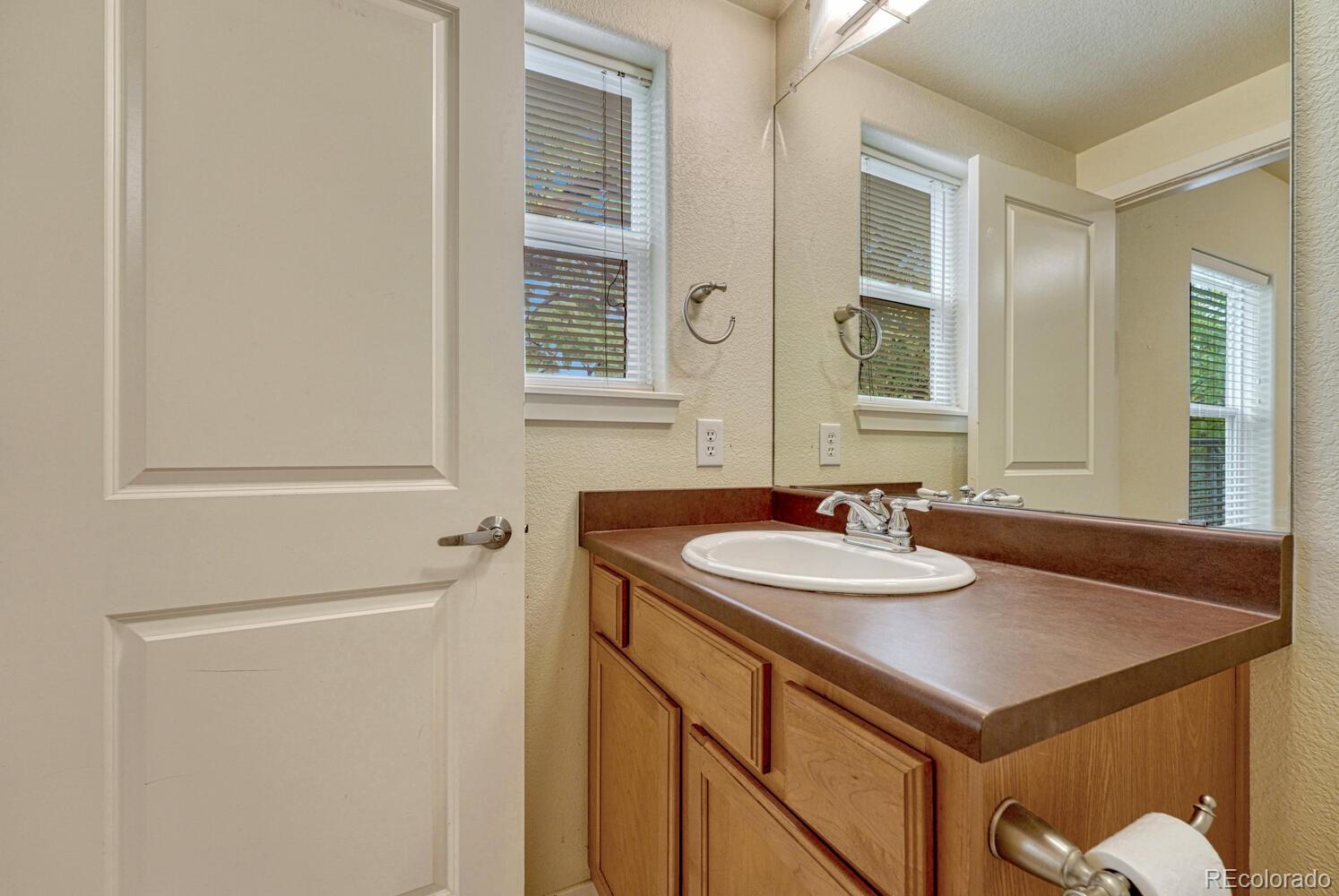 2389 South High Street, Unit 4 Denver, CO 80210 - Photo 16 of 27 a bathroom with a sink and a mirror