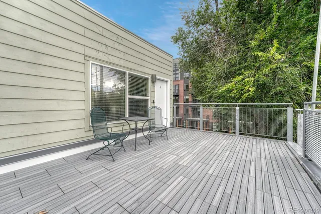 a view of balcony with wooden floor and fence
