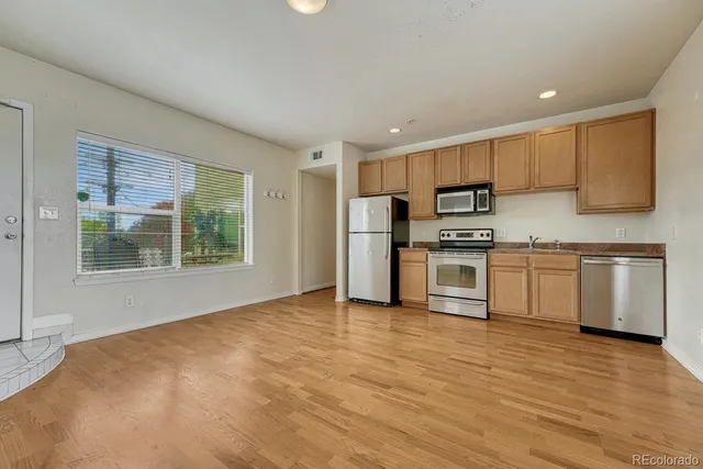 a kitchen with stainless steel appliances a refrigerator and a stove top oven
