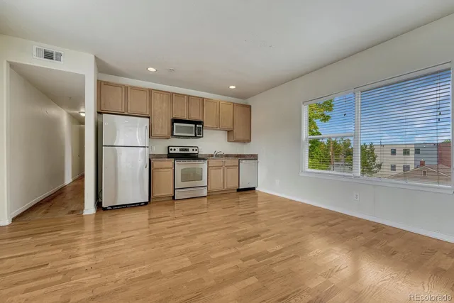 a kitchen with stainless steel appliances a refrigerator and a stove top oven