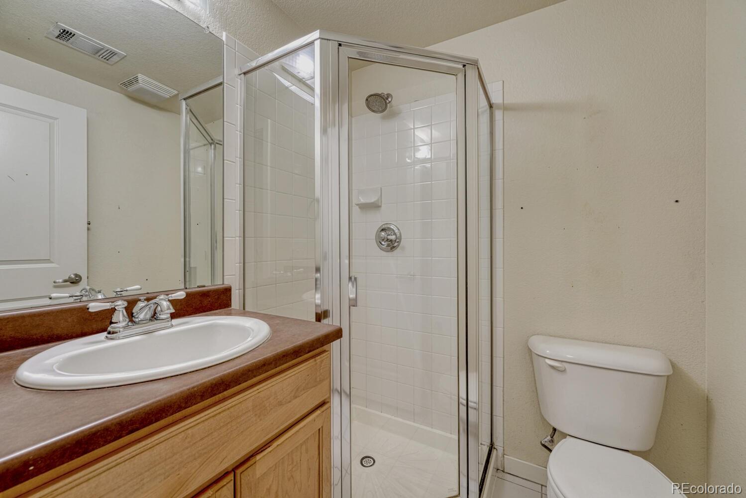 2389 South High Street, Unit 4 Denver, CO 80210 - Photo 10 of 27 a bathroom with a sink toilet and shower