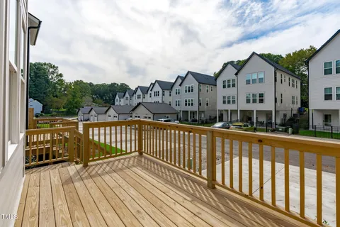 a view of a wooden deck with a yard